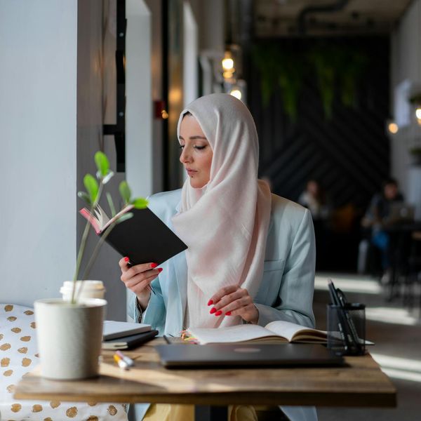 A person sitting calmly in a bright, modern workspace.